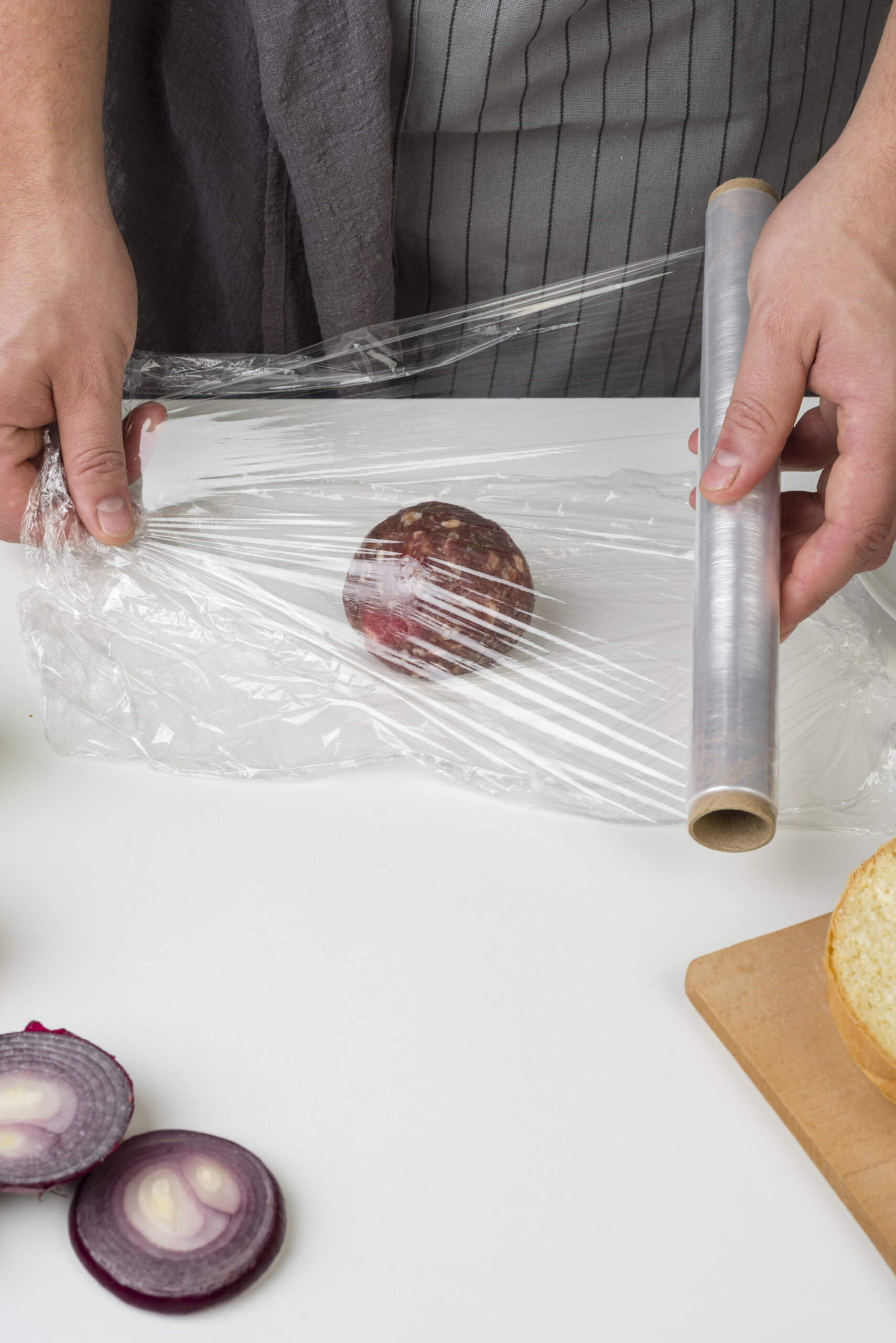 hands-packing-onion-with-plastic-foil (1)